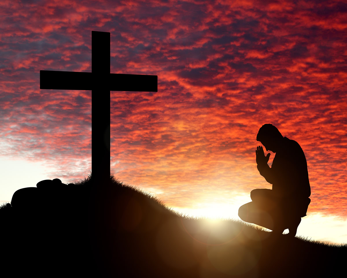 Man kneeling before the Cross
